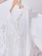 純白繡花 交叉鏤空織帶流蘇洋裝